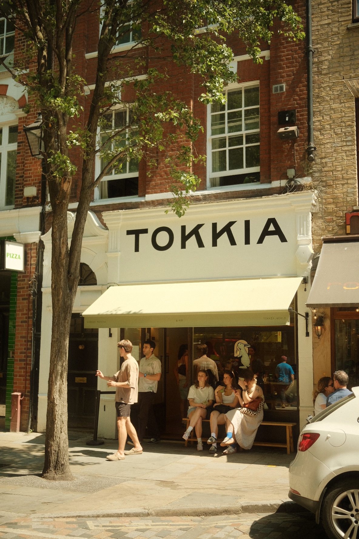 Tokkia Korean matcha cafe storefront on a sunlit London street.